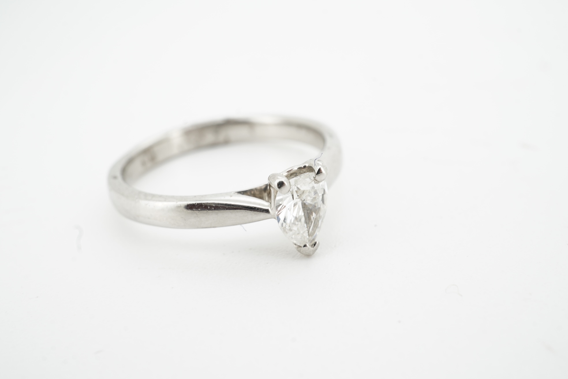 A diamond ring, claw-set with a pear-shaped diamond weighing approximately 0.45 carats, mounted in platinum, size L1/2, British hallmarks, gross weight approximately 4 grams